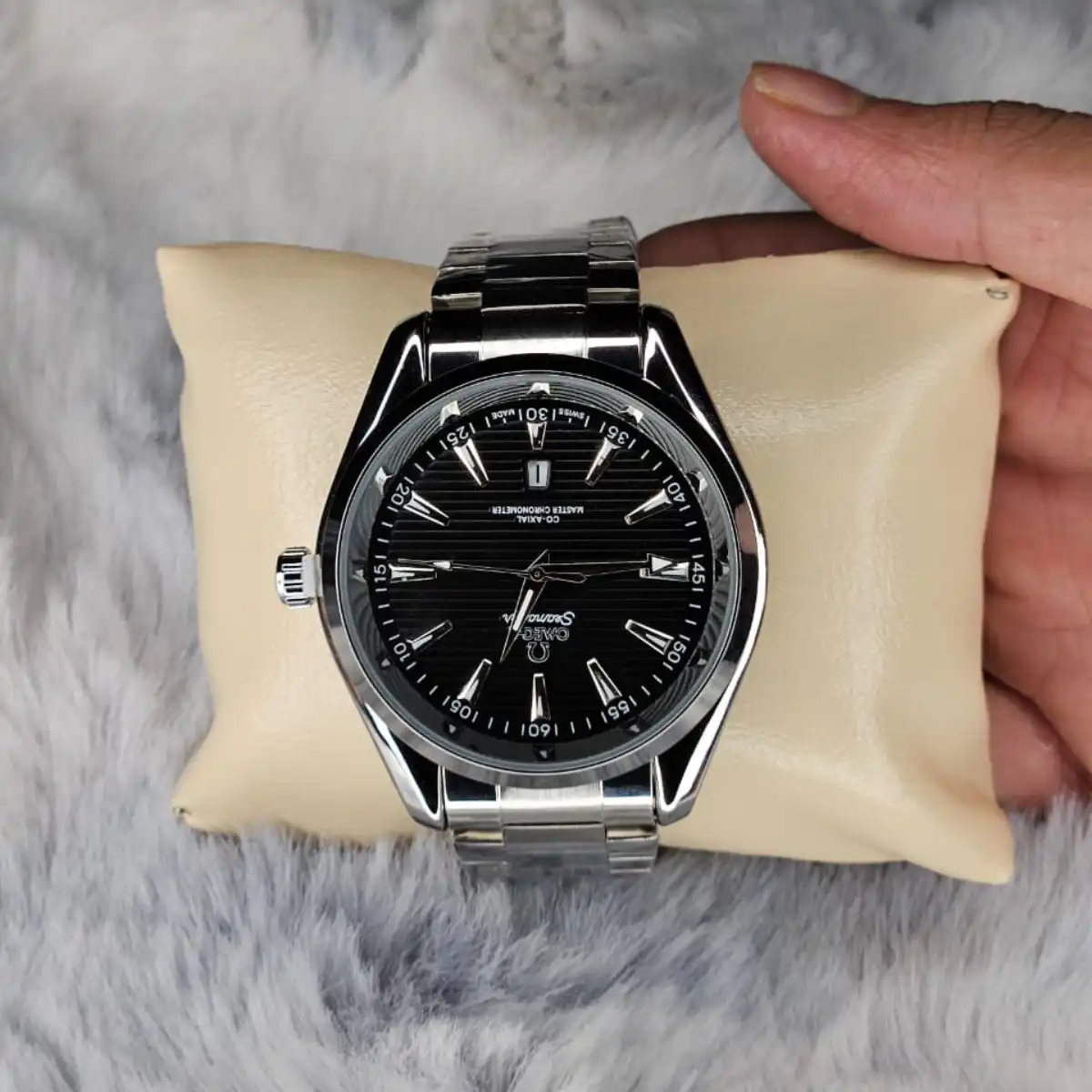 Flat lay of the Omega Premium Quartz Watch next to sunglasses and a leather wallet